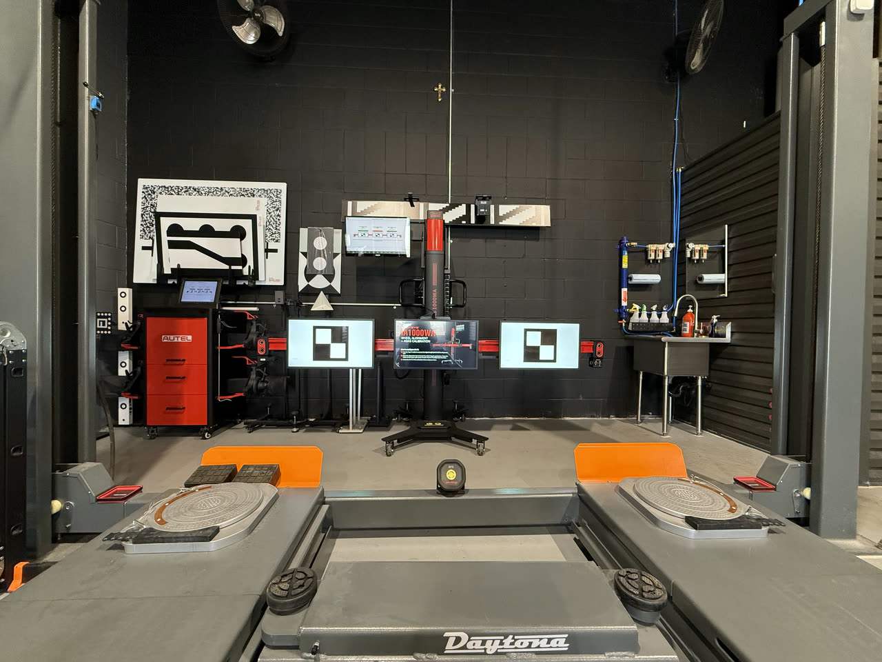 The alignment and ADAS calibration station, its target boards set up in front of the lift