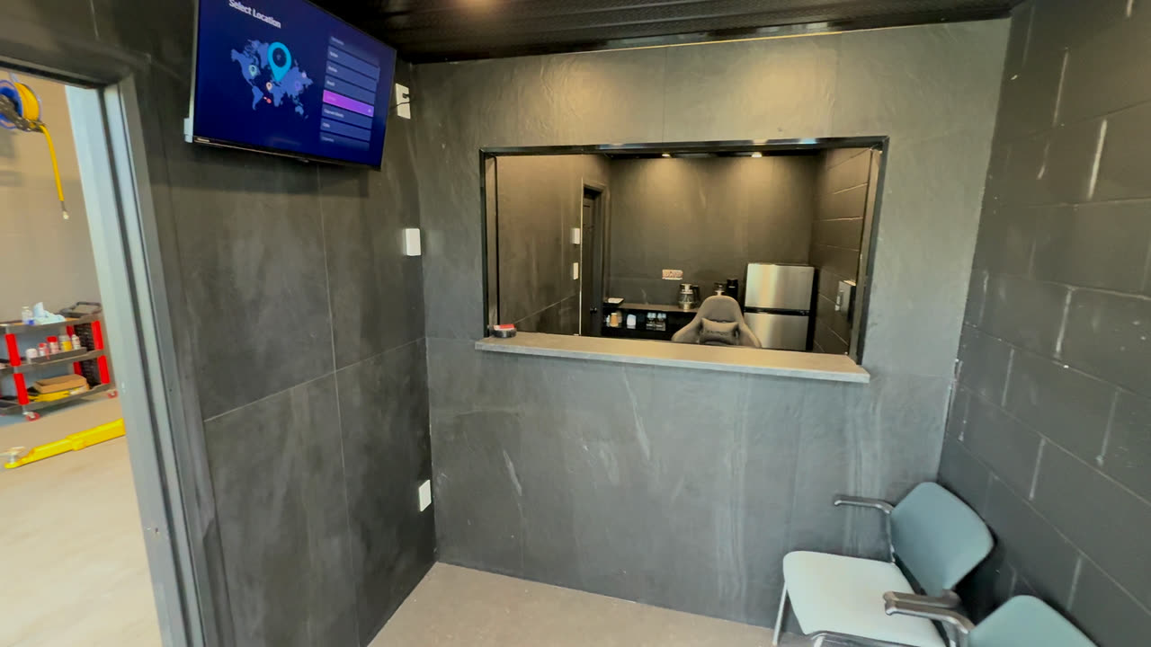 The waiting room, with the TV and the service window into the office