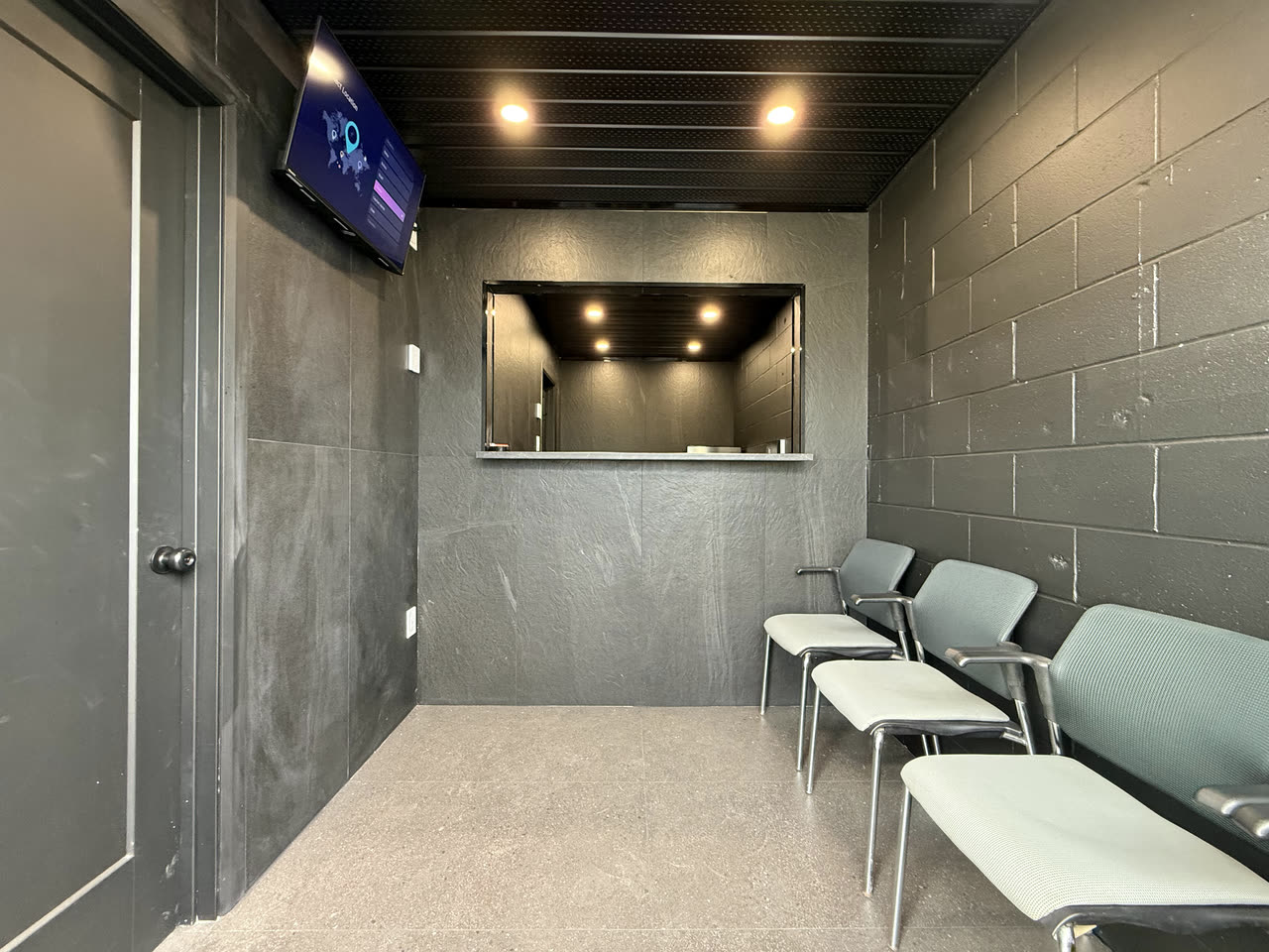 The waiting room and the service window into the office